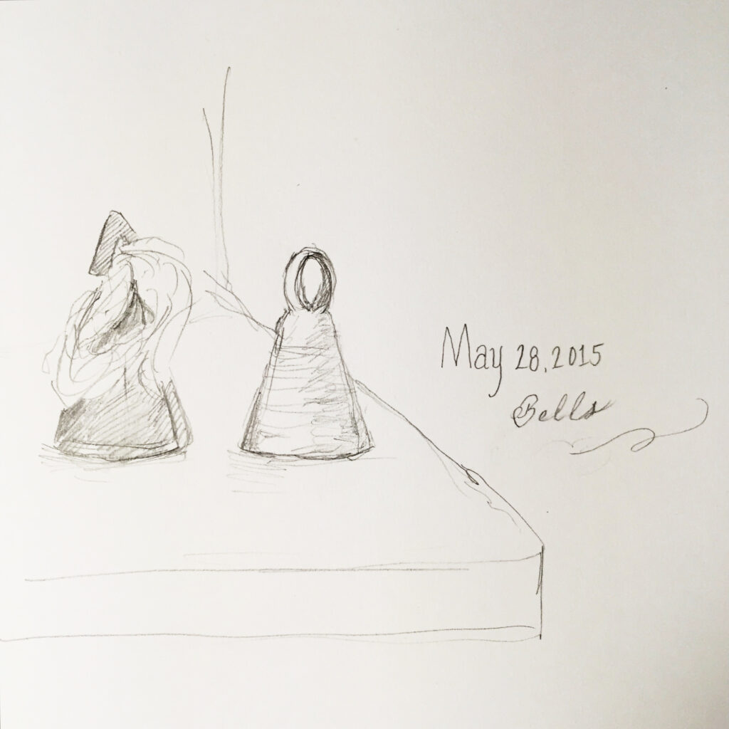light pencil sketch of metal bells on a cabinet